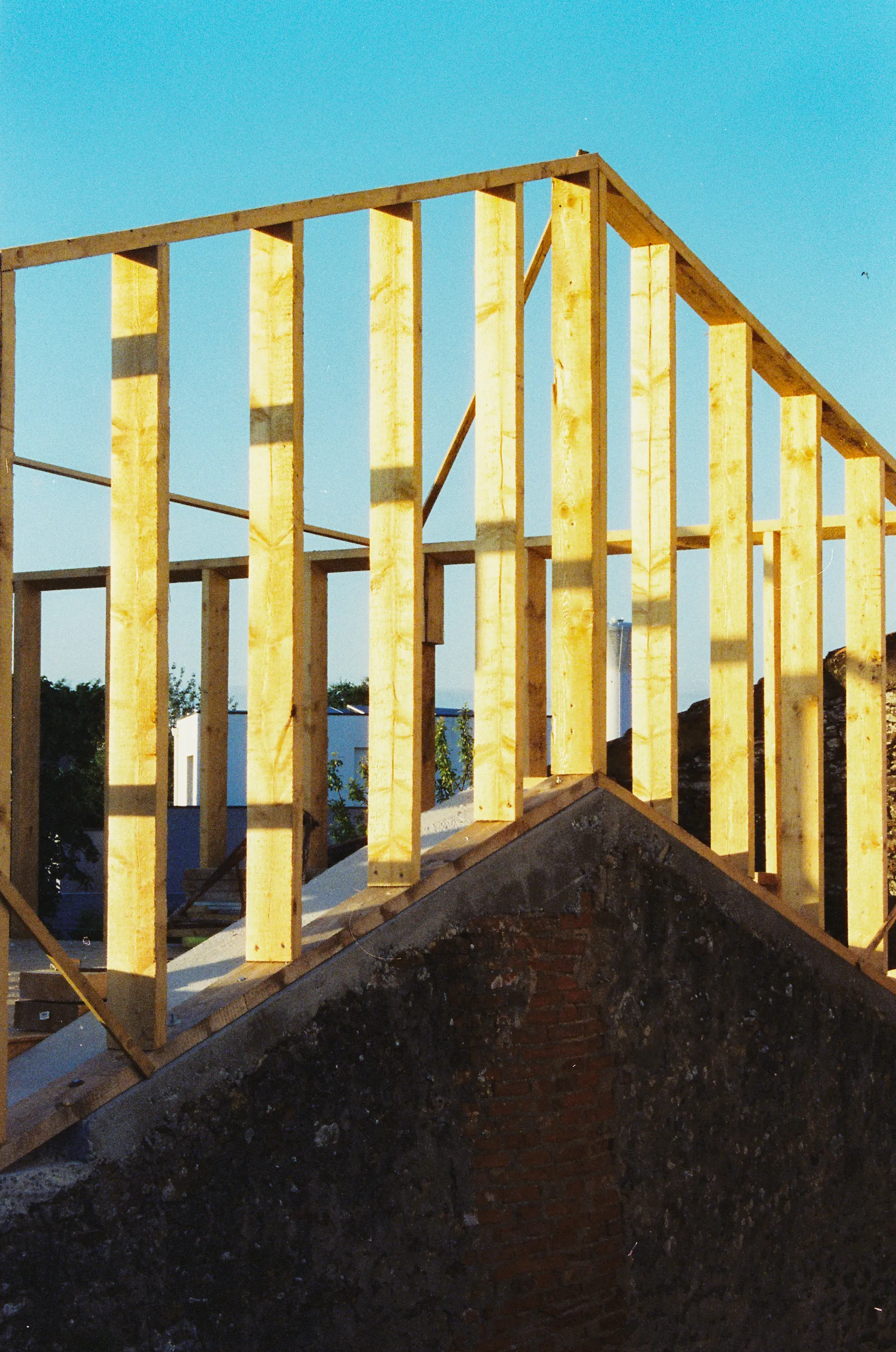 Homeowner signing a change order on a tablet beside an opened wall