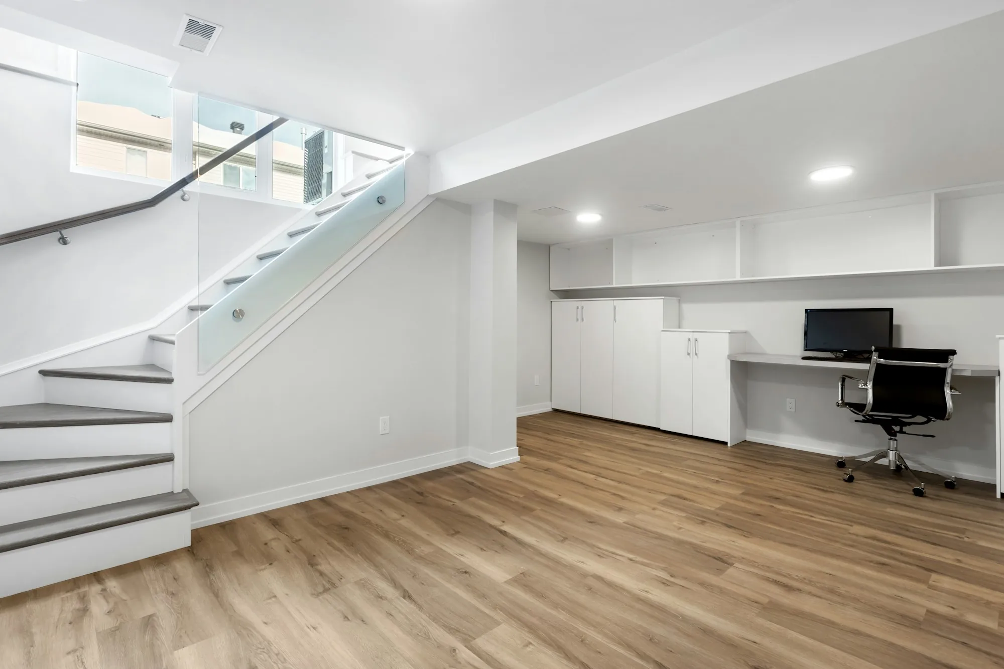 Finished basement with a family room, carpet and recessed lights