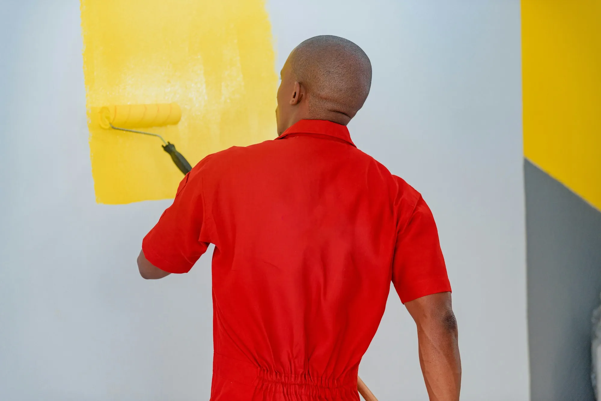 Painter cutting in along a ceiling line with a brush